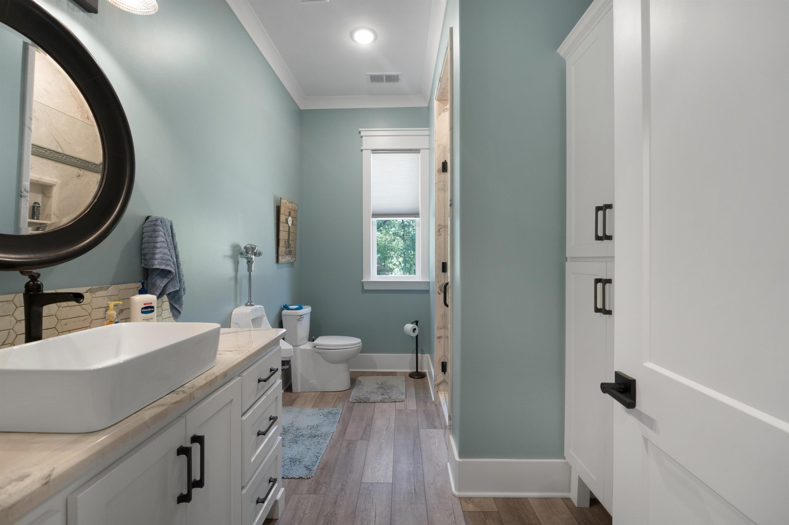 491 Cooper Anderson Road Jackson, TN 38305 - Photo 25 of 30 a bathroom with a double vanity sink a mirror and a toilet
