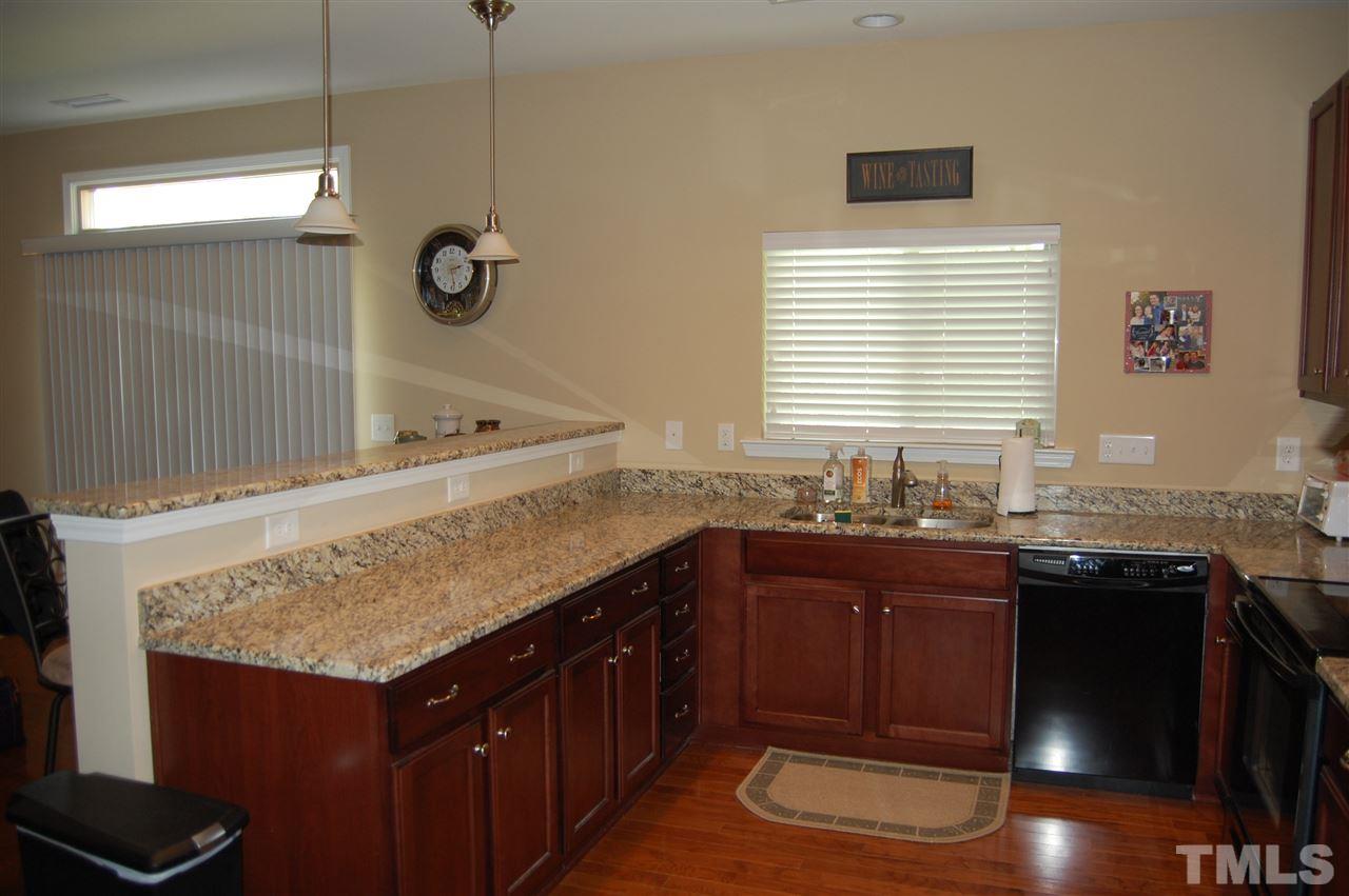 313 Riversville Court Cary, NC 27519 - Photo 4 of 25 Beautiful granite counter tops abound in this large kitchen was numerous cabinets. Window in kitchen overlooks back yard.