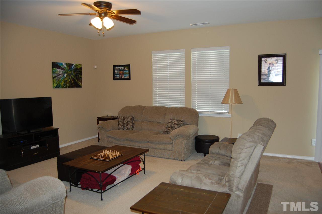 313 Riversville Court Cary, NC 27519 - Photo 7 of 25 Family room is open to the kitchen and breakfast area to one side and the foyer to the other side.