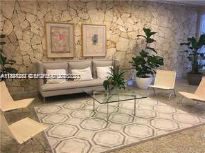 780 Northeast 69th Street, Unit 1406 Miami, FL 33138 - Photo 12 of 22 a living room with furniture and flowers