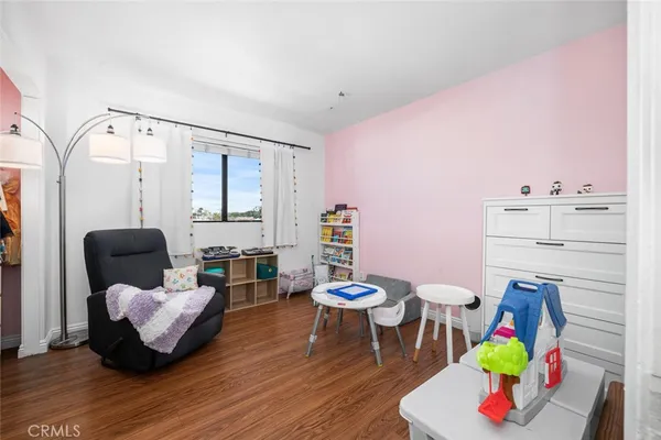 a bedroom with furniture and a wooden floor