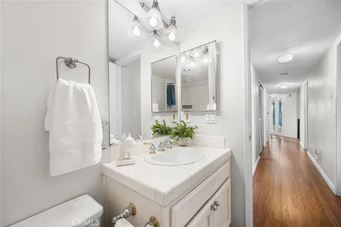 a kitchen with a sink and wooden floor