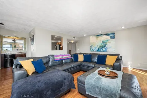 a living room with furniture and kitchen view