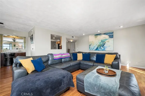 a living room with furniture and kitchen view