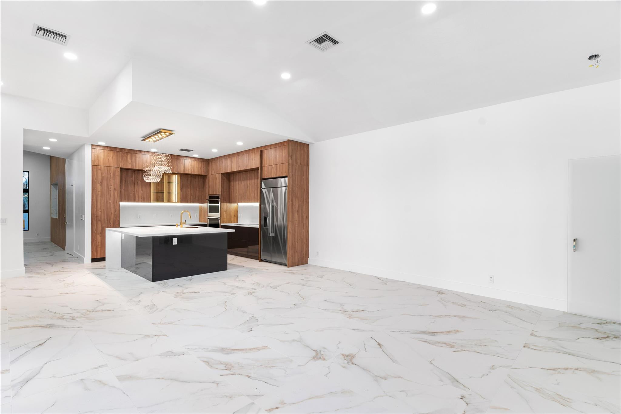 22722 El Dorado Drive Boca Raton, FL 33433 - Photo 37 of 50 a large kitchen with kitchen island a sink stainless steel appliances and cabinets