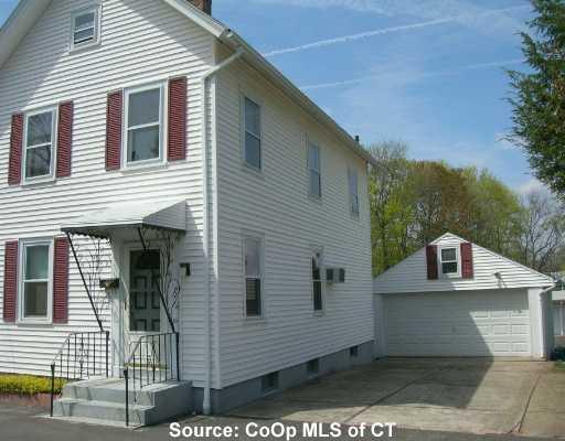a view of a white house with many windows