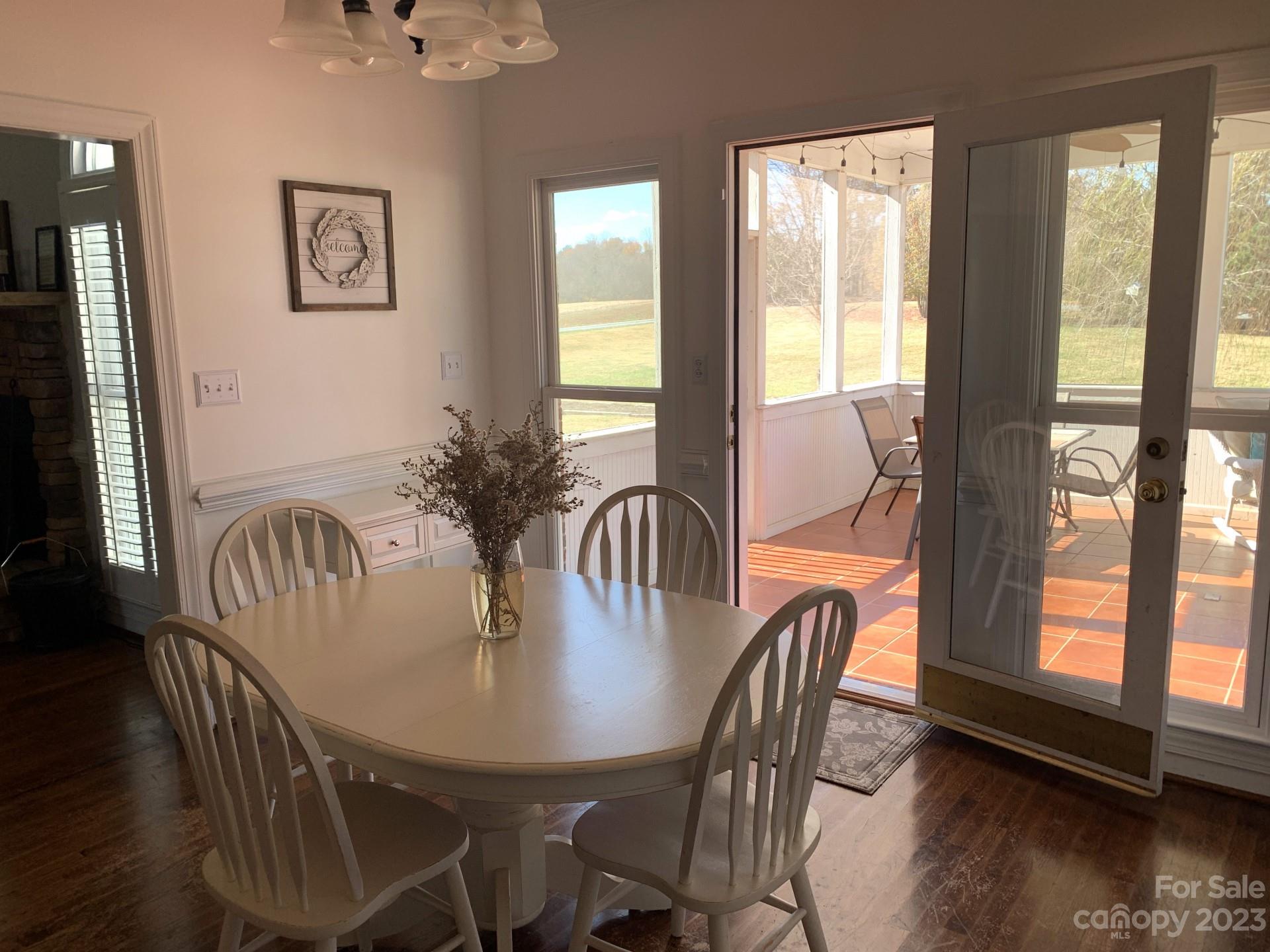 1026 Snyders Store Road Wingate, NC 28174 - Photo 19 of 34 a dining room with furniture window and wooden floor
