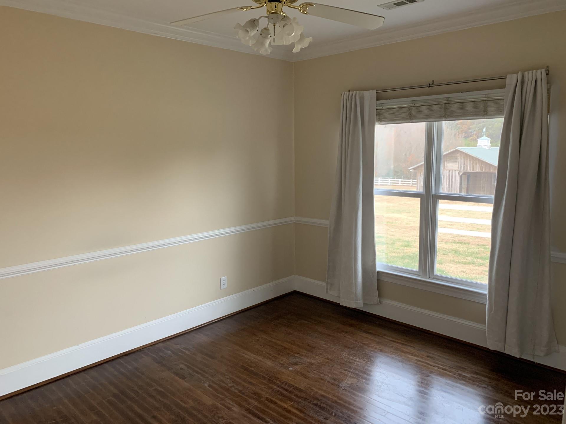 1026 Snyders Store Road Wingate, NC 28174 - Photo 33 of 34 an empty room with wooden floor and windows