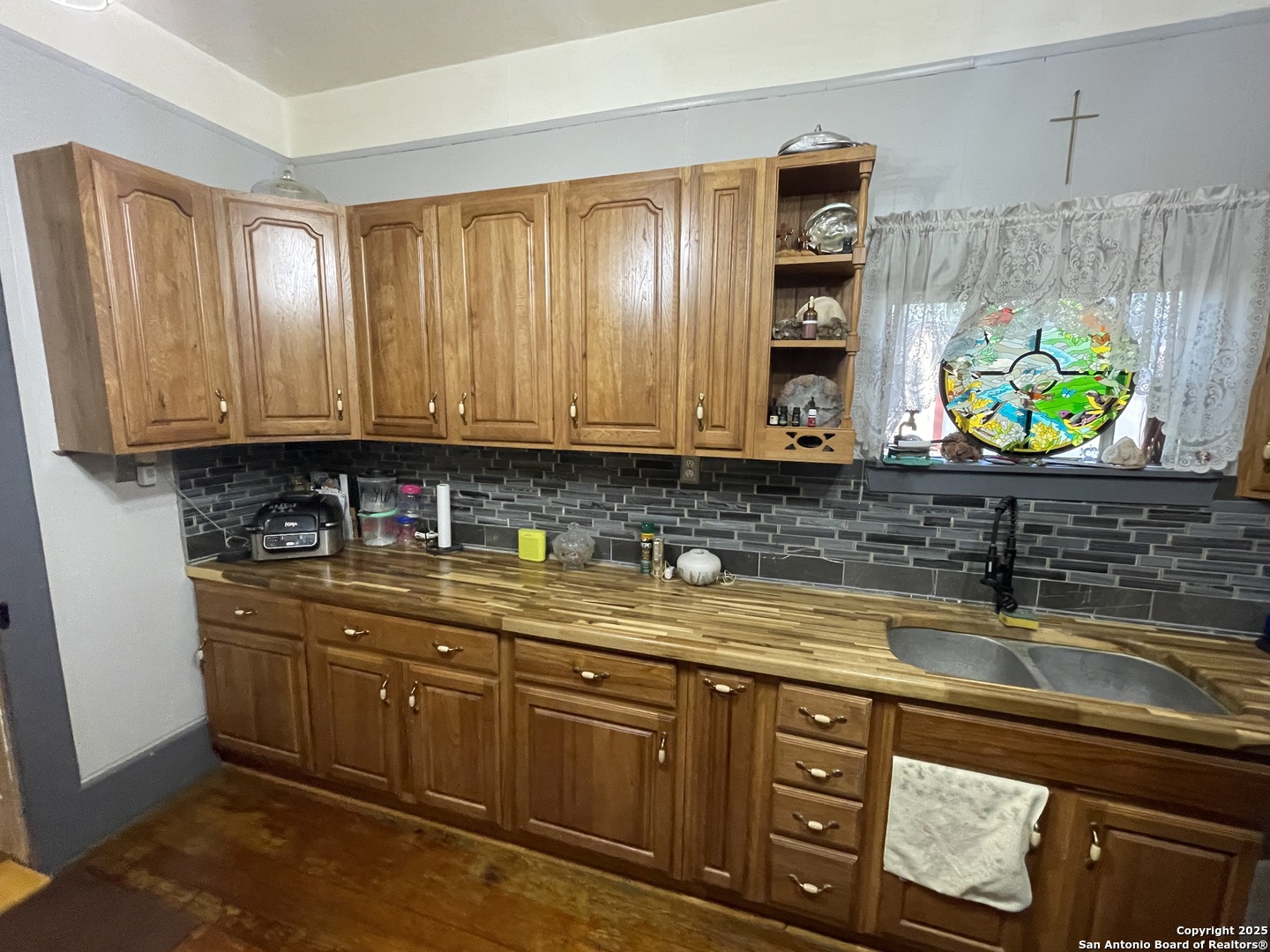 601 Berlin Street Castroville, TX 78009 - Photo 7 of 17 a kitchen with stainless steel appliances granite countertop a sink a stove and a microwave