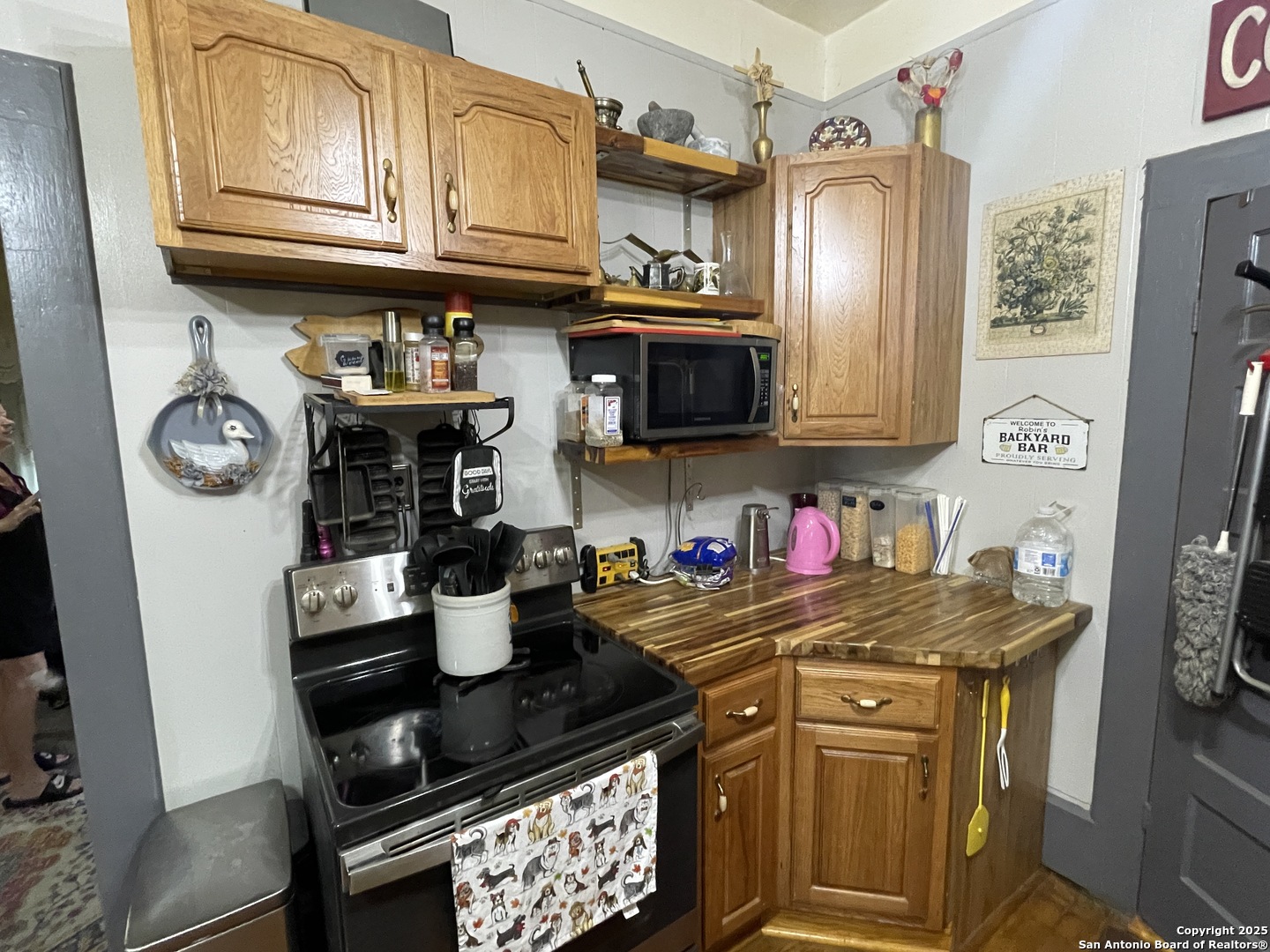 601 Berlin Street Castroville, TX 78009 - Photo 8 of 17 a kitchen with stainless steel appliances granite countertop a refrigerator and stove top oven