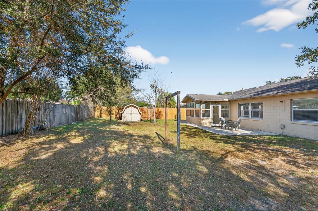 5438 Snowflake Court Orlando, FL 32839 - Photo 17 of 38 a view of a yard with a house and a tree