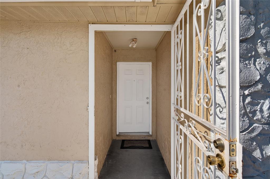 5438 Snowflake Court Orlando, FL 32839 - Photo 21 of 38 a view of a hallway with wooden door and stairs