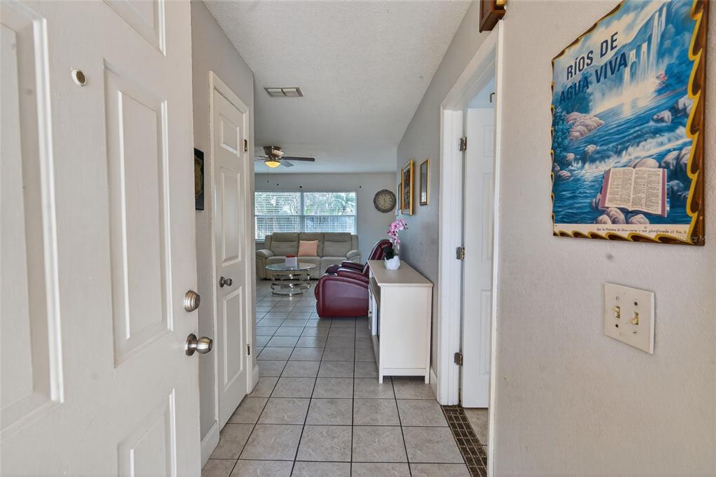 5438 Snowflake Court Orlando, FL 32839 - Photo 22 of 38 a view of a hallway with workspace and a couch