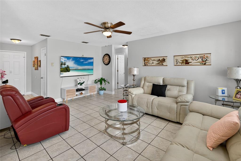 5438 Snowflake Court Orlando, FL 32839 - Photo 24 of 38 a living room with furniture and a flat screen tv