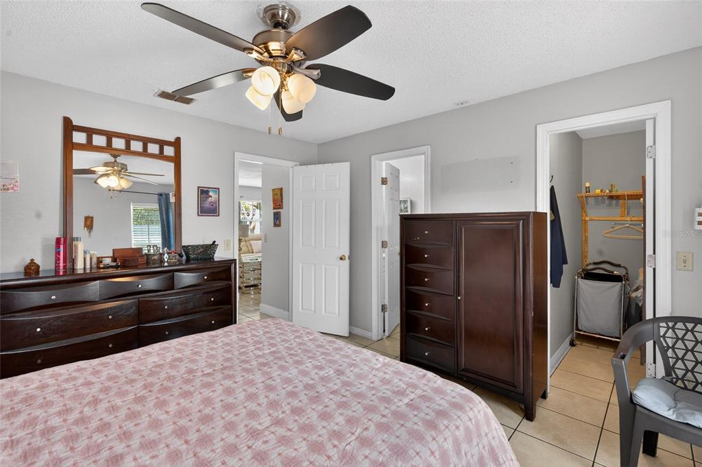 5438 Snowflake Court Orlando, FL 32839 - Photo 34 of 38 a bed room with a bed and a dresser