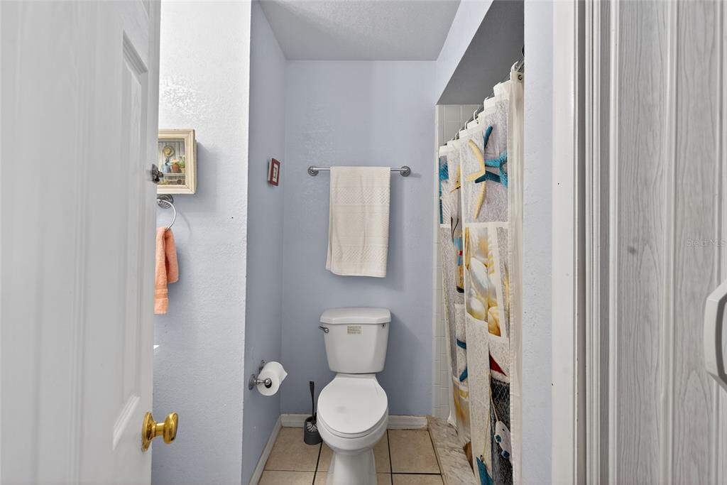 5438 Snowflake Court Orlando, FL 32839 - Photo 35 of 38 a white toilet sitting next to a bathroom