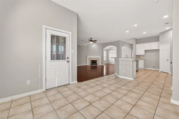 a view of a kitchen with furniture and wooden cabinets