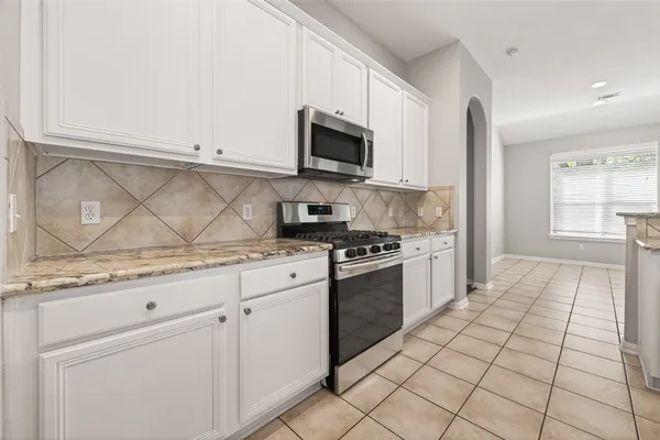 a kitchen with stainless steel appliances granite countertop a stove and a sink