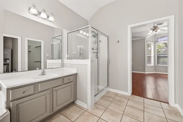 a bathroom with a granite countertop sink a mirror and a vanity