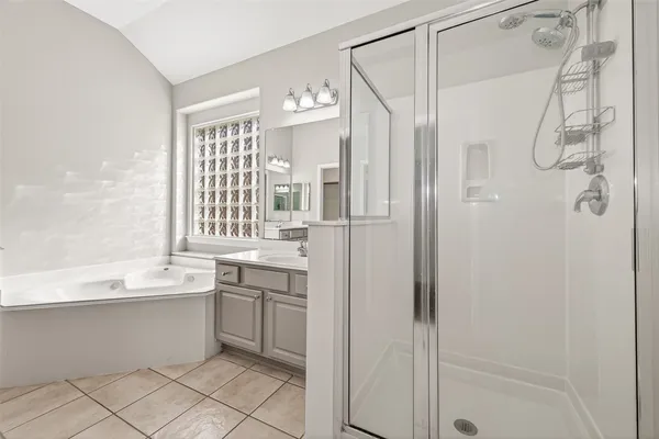 a bathroom with a shower sink and mirror