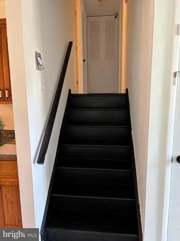 a view of staircase with white walls and a window