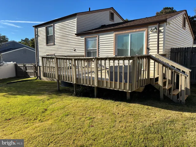 a view of a house with a wooden deck