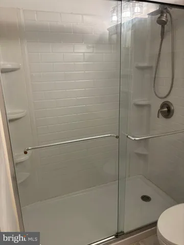 a bathroom with a glass shower door