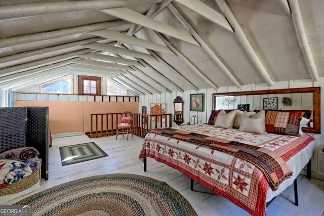 a view of a yard with plants and large trees