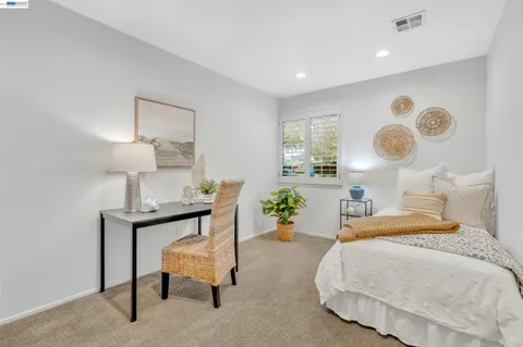 a bedroom with a bed and large mirror