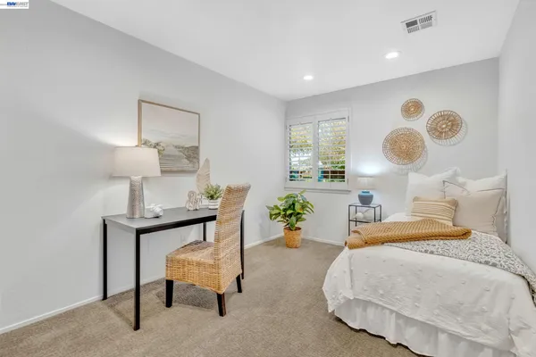 a bedroom with a bed and large mirror