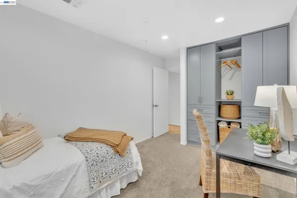a bathroom with a sink a mirror and a painting on the wall