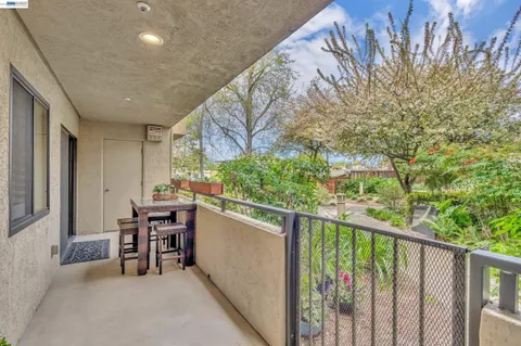 a dining room with furniture and a potted plant