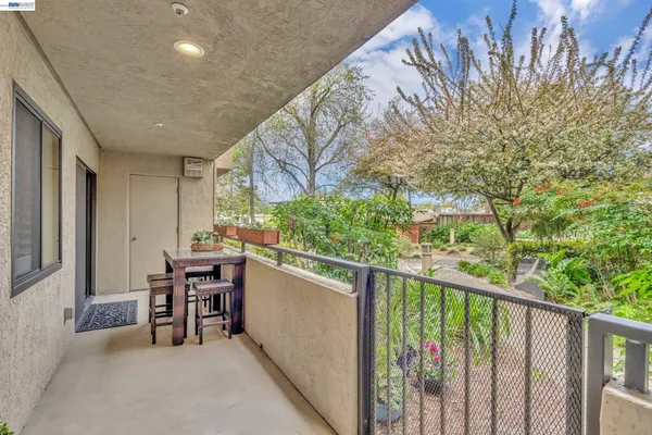 a dining room with furniture and a potted plant