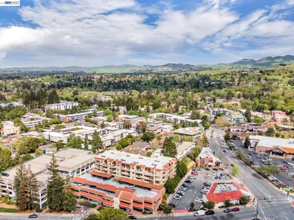 an aerial view of residential houses with city view