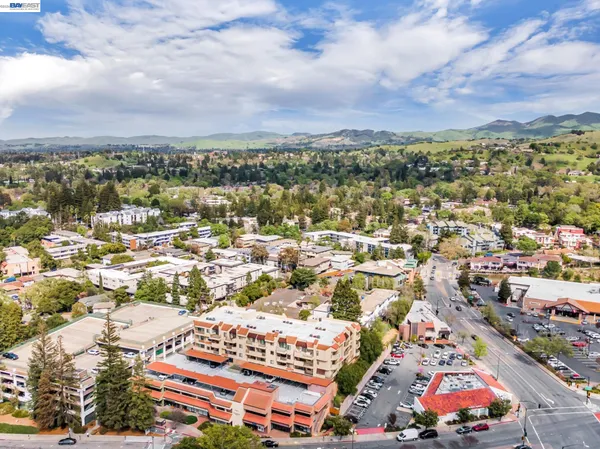 an aerial view of residential houses with city view