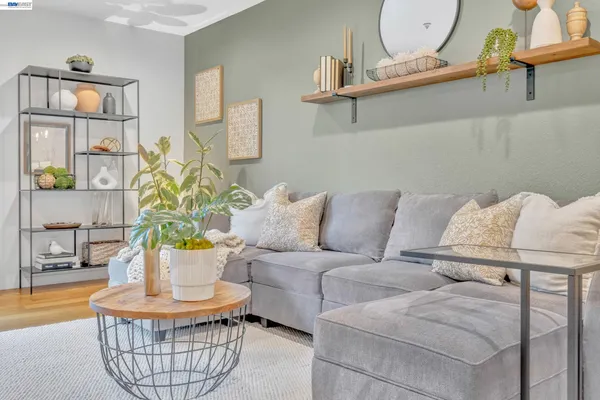 a living room with furniture a couch and potted plants