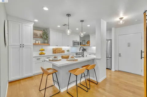 a kitchen with stainless steel appliances kitchen island granite countertop a sink and cabinets