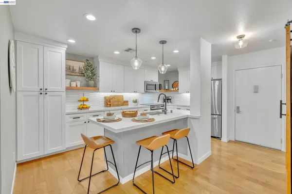 a kitchen with stainless steel appliances kitchen island granite countertop a sink and cabinets