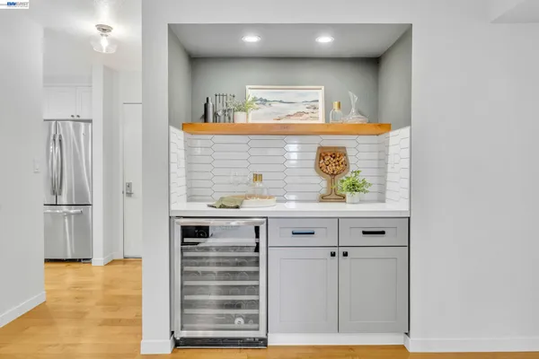 a view of kitchen with refrigerator and window