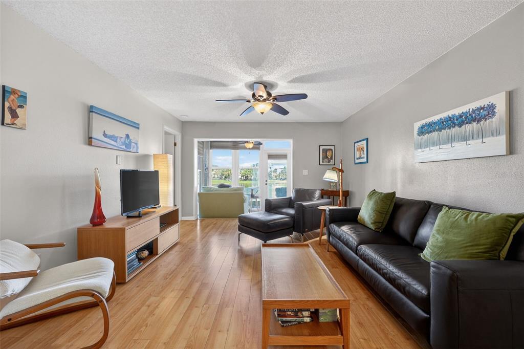 1438 Millstream Lane, Unit 105 Dunedin, FL 34698 - Photo 11 of 34 a living room with furniture fireplace and a flat screen tv