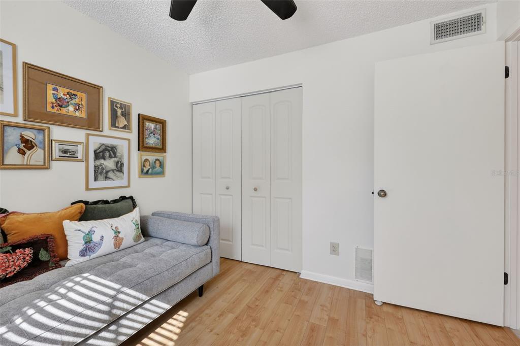 1438 Millstream Lane, Unit 105 Dunedin, FL 34698 - Photo 24 of 34 a living room with furniture and wooden floor