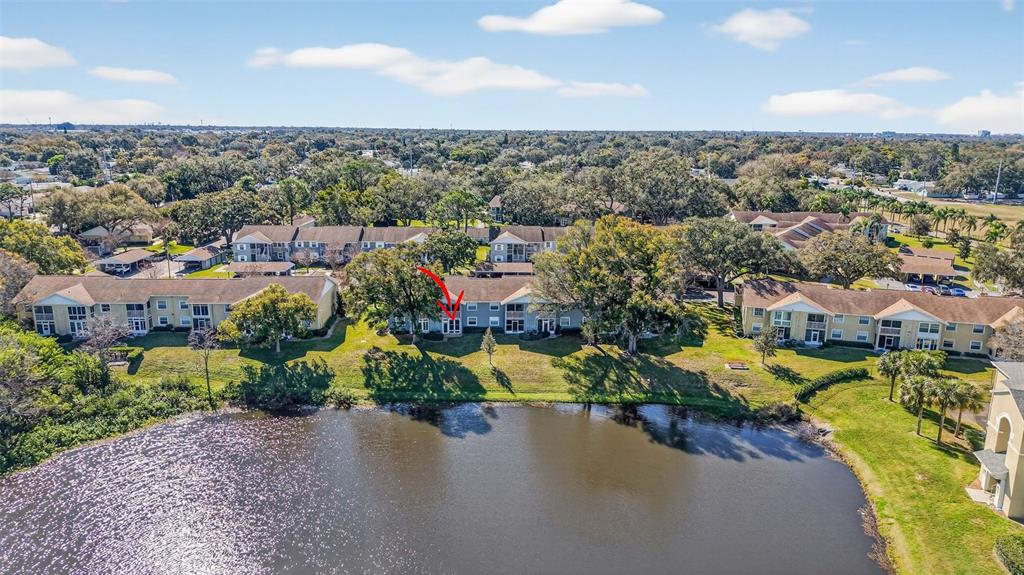 1438 Millstream Lane, Unit 105 Dunedin, FL 34698 - Photo 30 of 34 an aerial view of a houses with a street