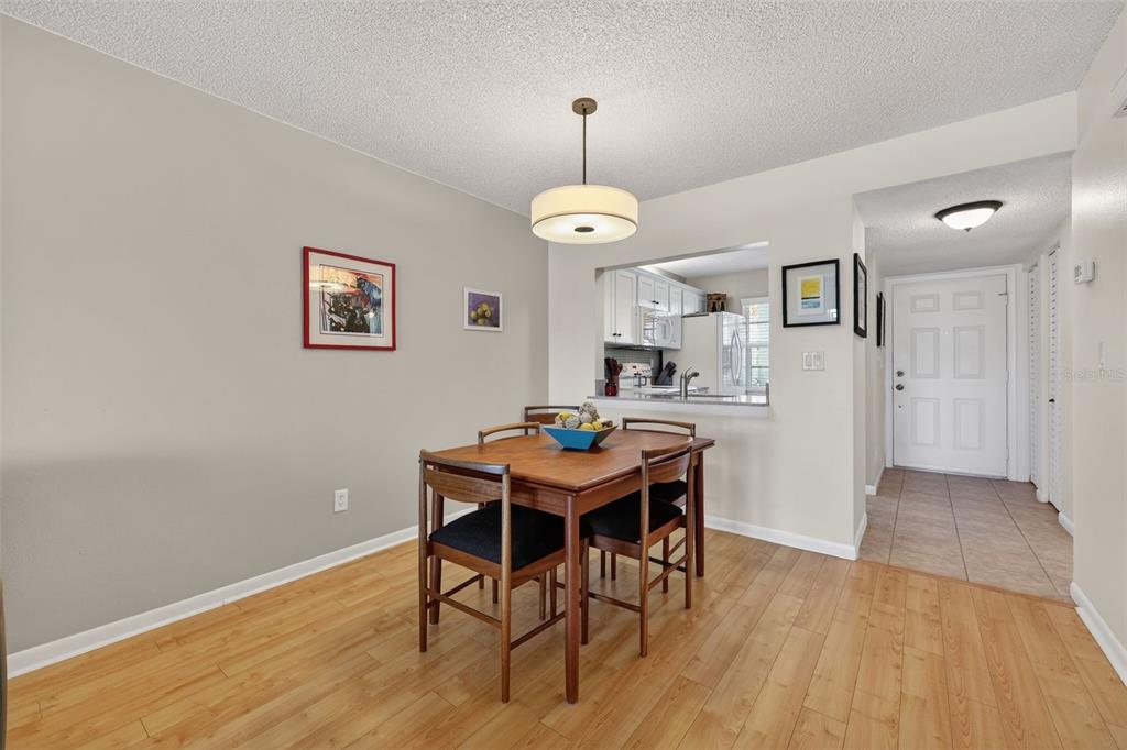1438 Millstream Lane, Unit 105 Dunedin, FL 34698 - Photo 10 of 34 a view of a dining room with furniture window and wooden floor