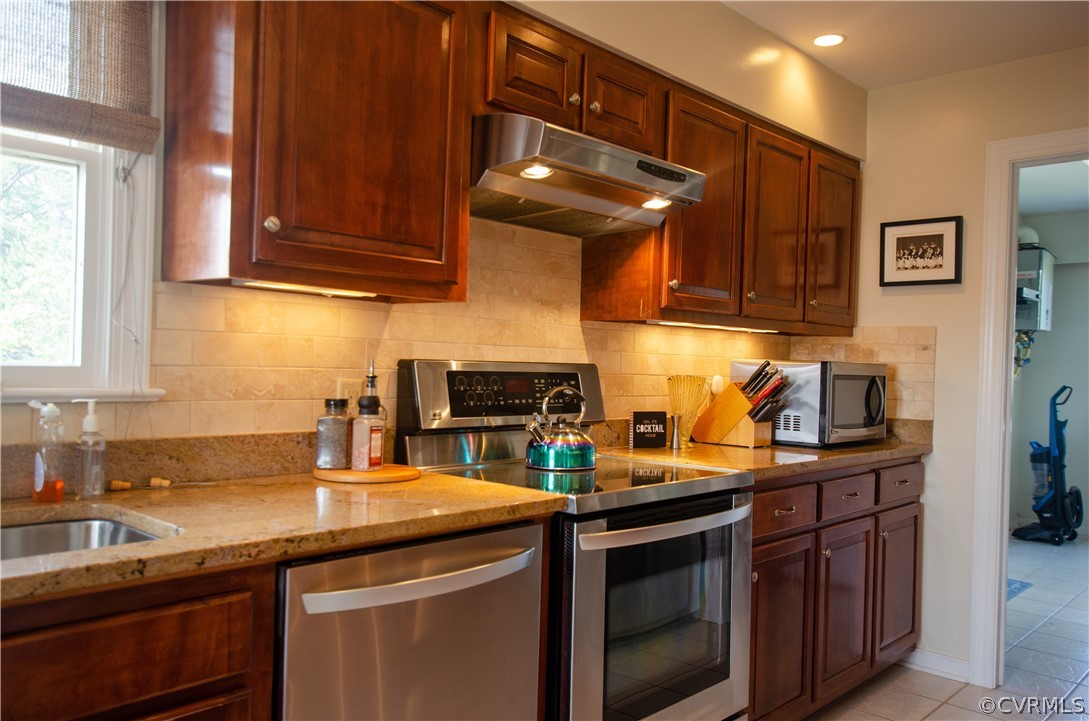 4773 Windmill Point Road White Stone, VA 22578 - Photo 13 of 36 a kitchen with stainless steel appliances granite countertop a sink stove and cabinets