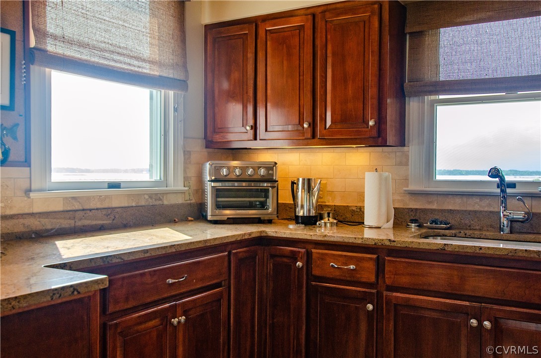 4773 Windmill Point Road White Stone, VA 22578 - Photo 14 of 36 a kitchen with granite countertop a sink cabinets and window