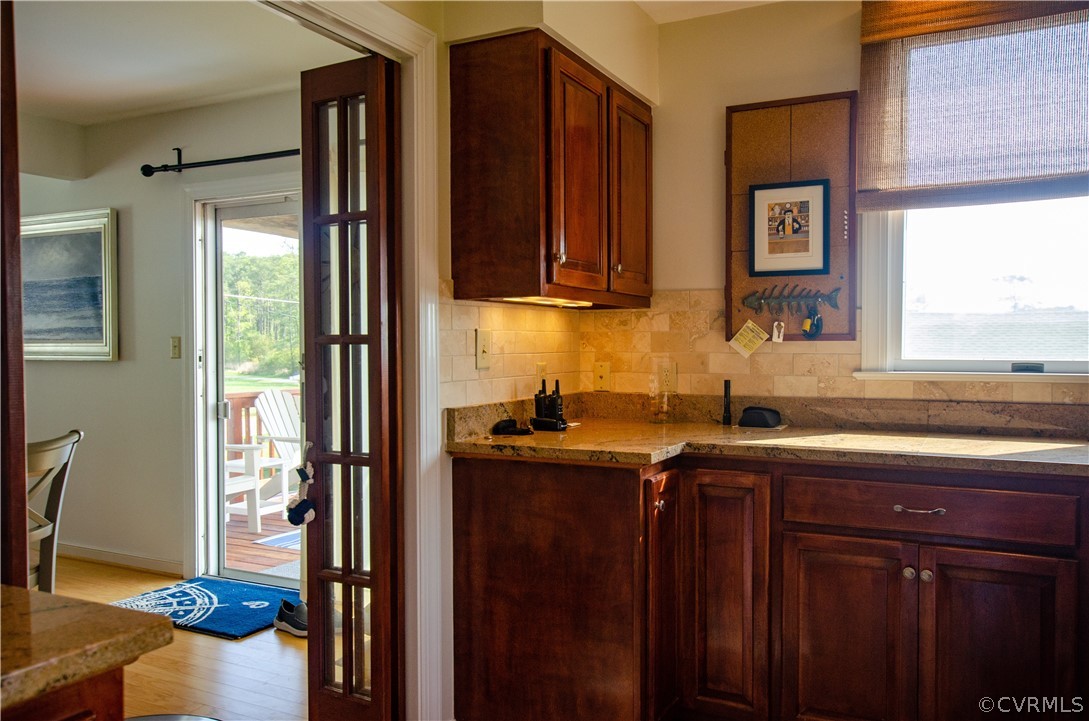 4773 Windmill Point Road White Stone, VA 22578 - Photo 15 of 36 a kitchen with stainless steel appliances granite countertop a sink stove and cabinets