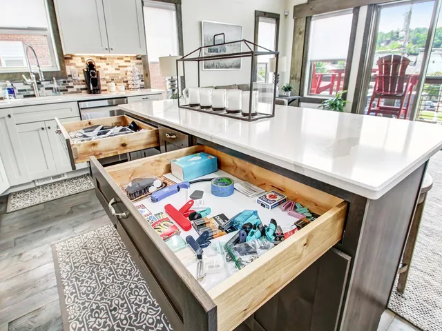 a living room with furniture and a dining table with kitchen view