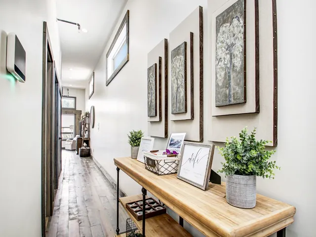 a dining room with furniture and potted plant