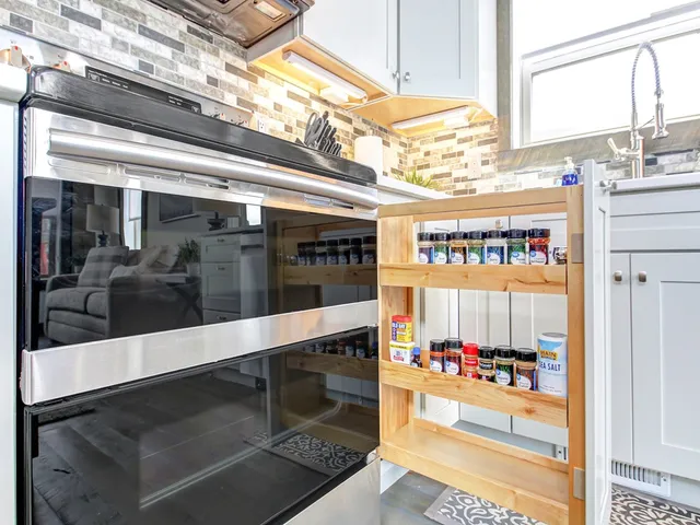 a view of a hallway with the view of living room washer and dryer