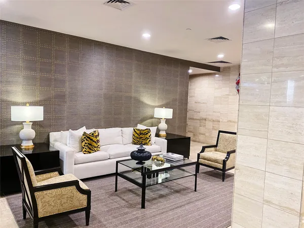 a living room with furniture and a lamp